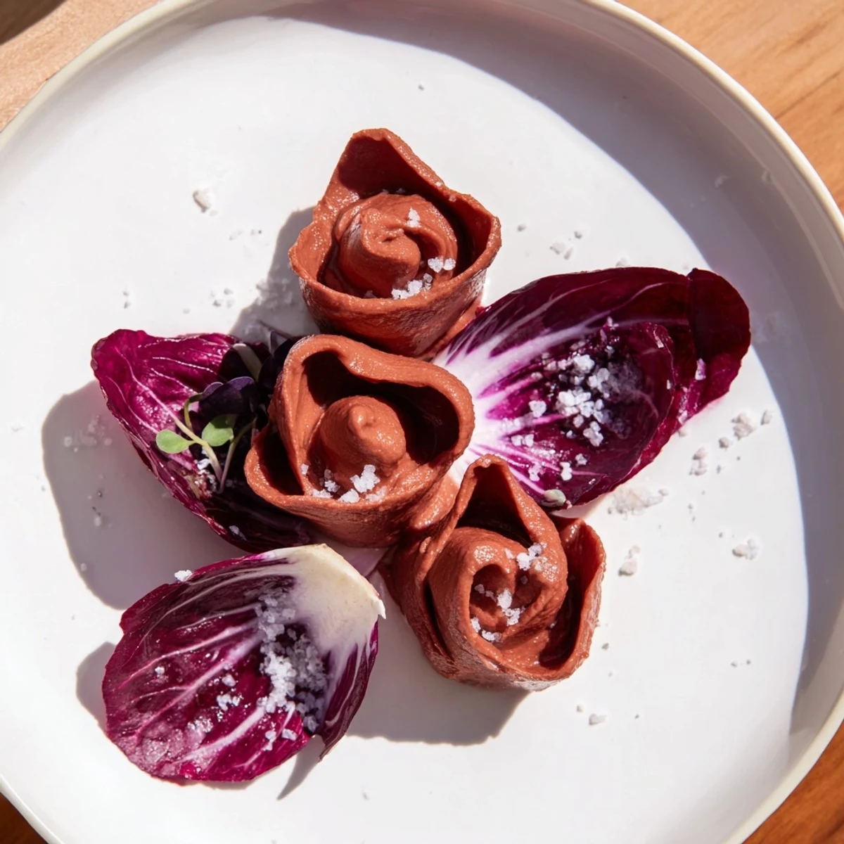 Vibrant beet hummus roses of "The Velvet Rose" appetizer are nestled with crisp, bitter radicchio.