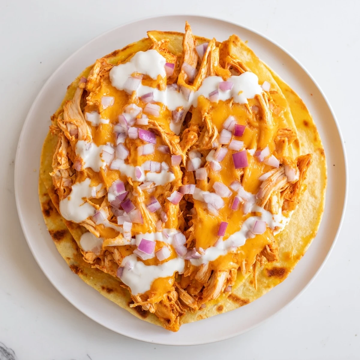 A close-up of a delicious Buffalo Chicken Quesadilla, brimming with flavorful chicken and cheese fillings.