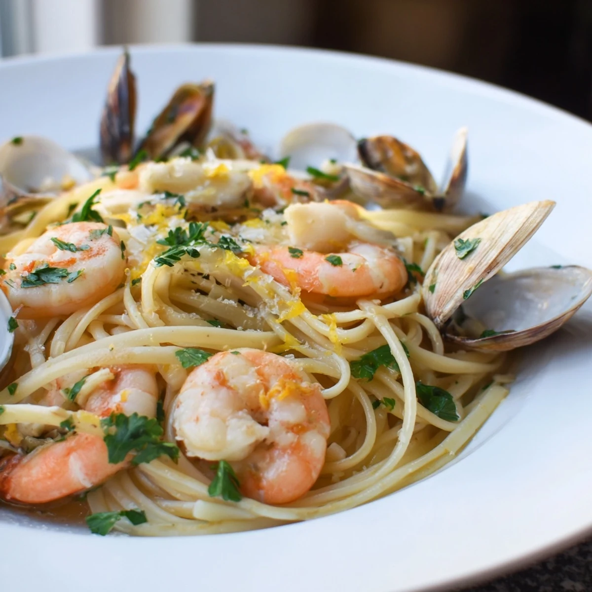 Freshly cooked Seafood Linguine garnished with parsley and lemon wedges, ready to serve for a pescatarian dinner.