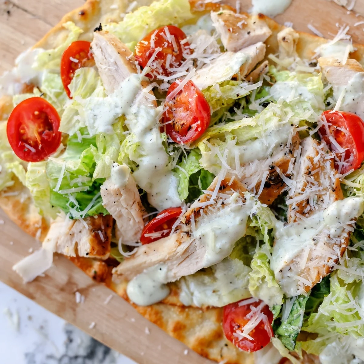 Golden-brown Caesar Chicken Flatbread topped with juicy grilled chicken and fresh romaine lettuce.