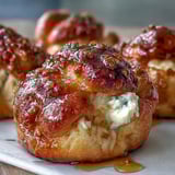 Golden-brown Hot Honey Ricotta Stuffed Garlic Knots with melted butter and fresh parsley.