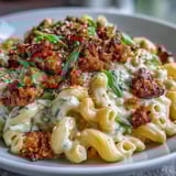 A close-up shows glossy Korean-Style Turkey Mac & Cheese, with melty cheddar and a drizzle of sweet-spicy sauce.