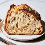 Steaming, crusty, artisan-style The Best Easy No-Knead Bread fresh out of the Dutch oven.