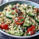 Refreshing Mediterranean orzo pasta salad featuring crisp cucumber, creamy feta, and zesty lemon vinaigrette.  