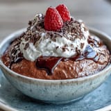 Creamy cottage cheese chocolate mousse topped with fresh berries on a spoon.
