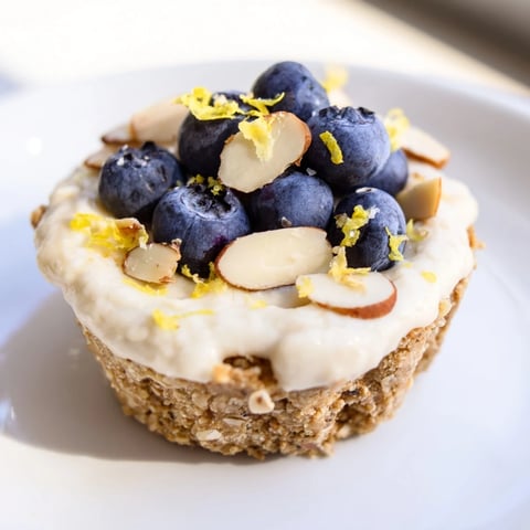 Protein cheesecake cups, ready to eat, topped with fresh berries and chocolate shavings.