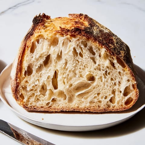 Steaming, crusty, artisan-style The Best Easy No-Knead Bread fresh out of the Dutch oven.