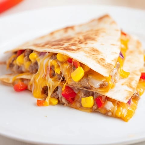 Warm, cheesy sheet pan quesadillas offer a delightful blend of textures and savory flavors.