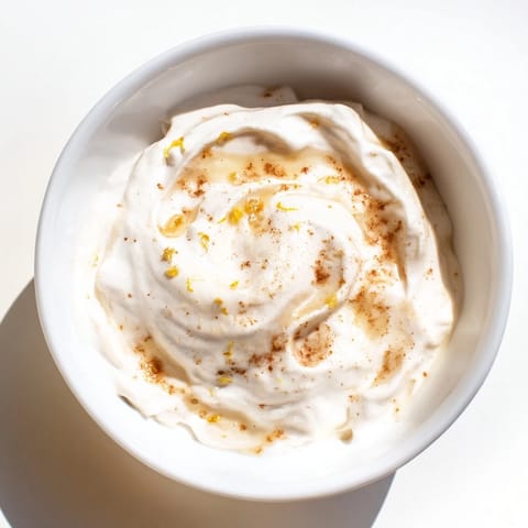 Close-up of a bowl of fluffy Greek yogurt fruit dip, perfect for a refreshing snack.