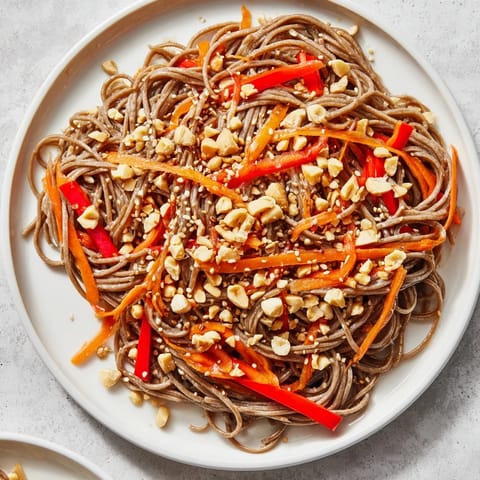 Vibrant Cold Noodle Salad, showcasing soba noodles, crunchy vegetables, and the creamy sesame-ginger dressing.