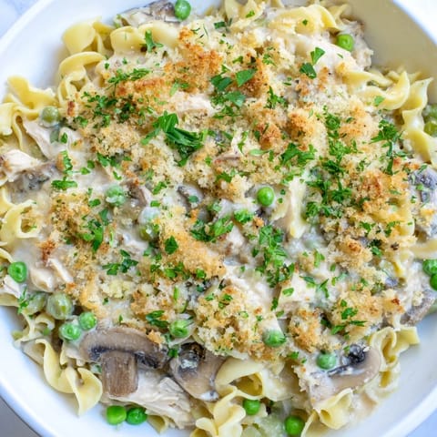 Bubbling hot Tuna Noodle Casserole 2.0 with tender noodles and a rich, creamy sauce.