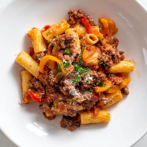 A close-up of Sausage and Peppers Pasta, showcasing tender sausage and flavorful sauce.