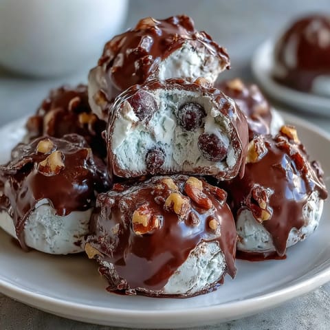Wholesome blueberry walnut yogurt clusters dipped in rich dark chocolate, ideal for quick, nutritious snacking.  