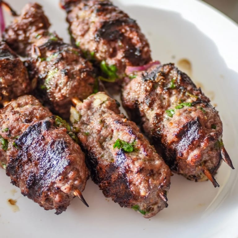 Close-up of perfectly charred Iraqi Kebab Tikka; imagine the savory aroma emanating from the grill.