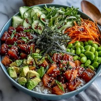 Vibrant Salmon Poke Bowl with creamy avocado and edamame, ready to eat.